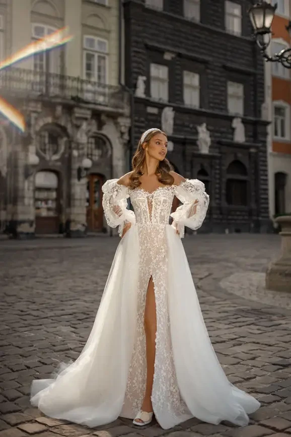 Bridal gown with overskirt and detachable sleeves